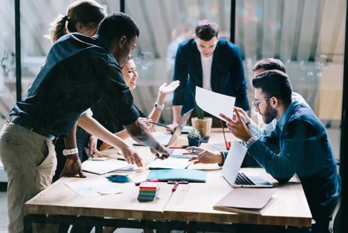 A diverse business team collaborating around a table in a modern office.